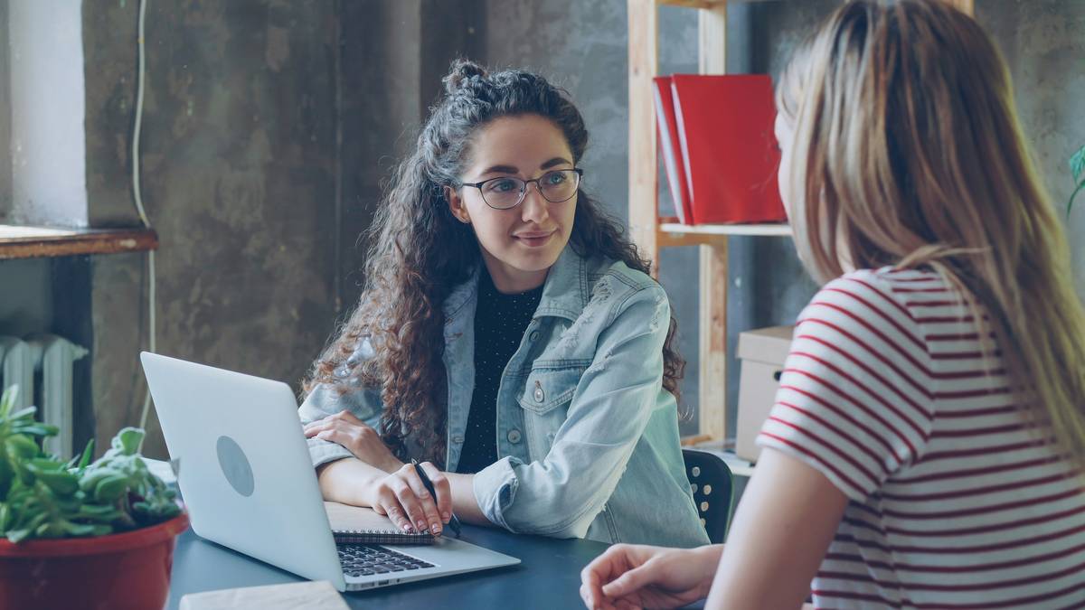 A certified career transition coach guiding a professional through a career pivot worksheet